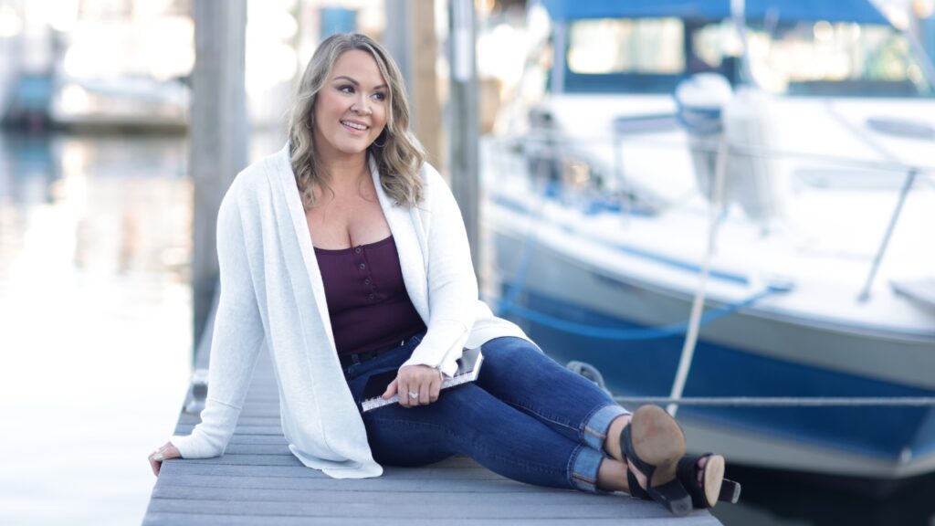 photo of woman lounging on a dock and staring off in the distance