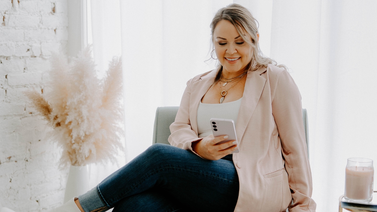 photo of girl sitting down looking at her phone