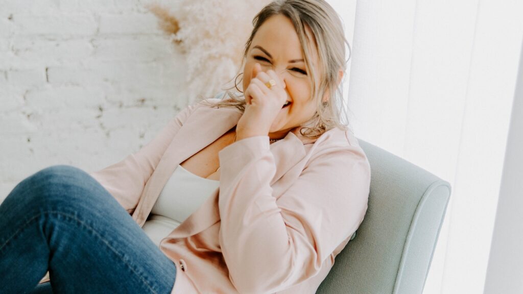 photo of woman laughing on chair